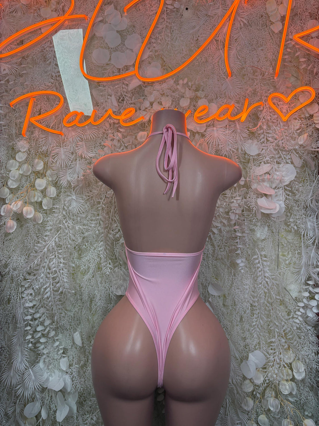 Pink one-piece bodysuit back with tie straps and high-cut bottom