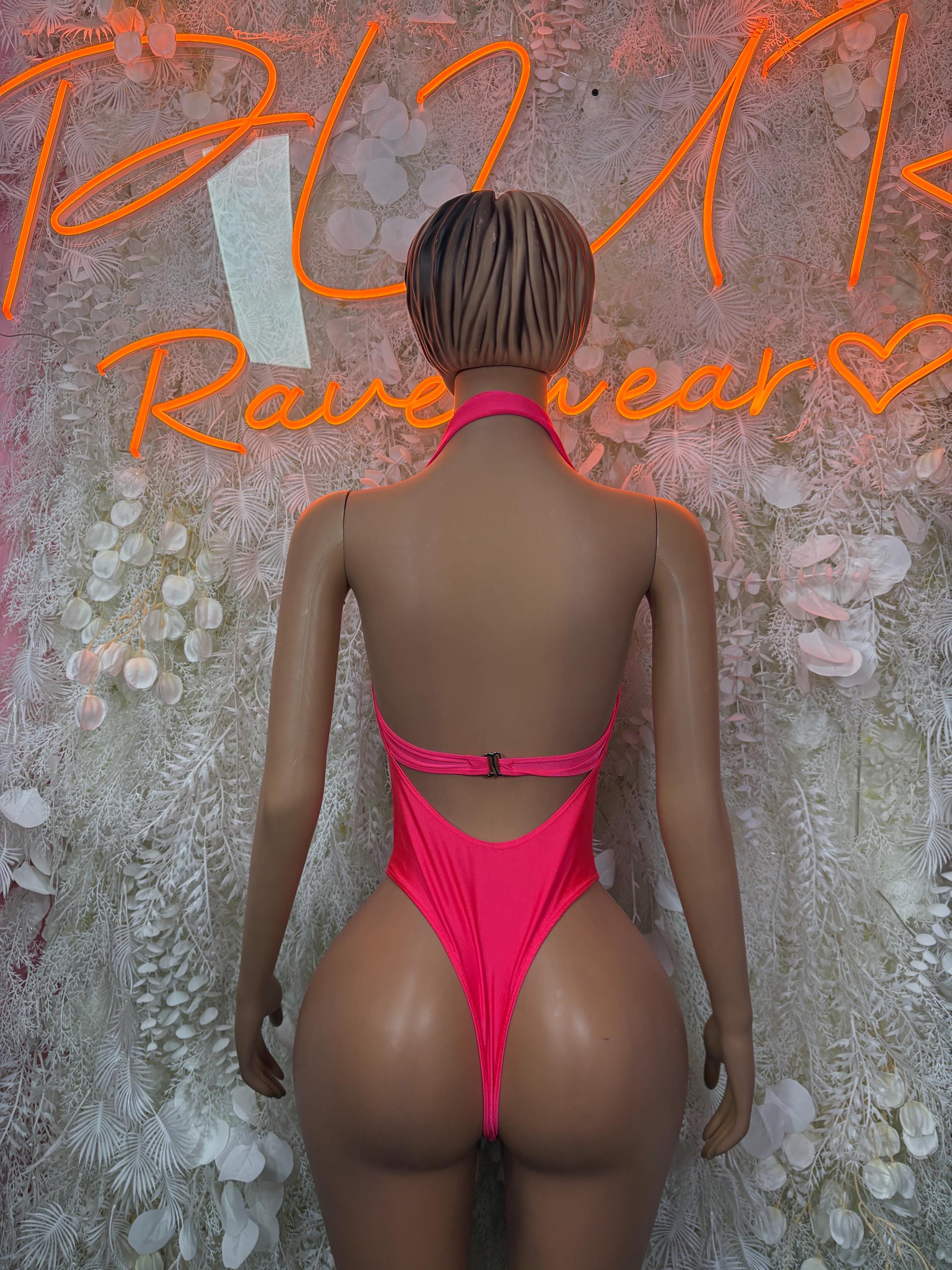 Hot pink one-piece bodysuit, low back and thong-style bottom with strap detail