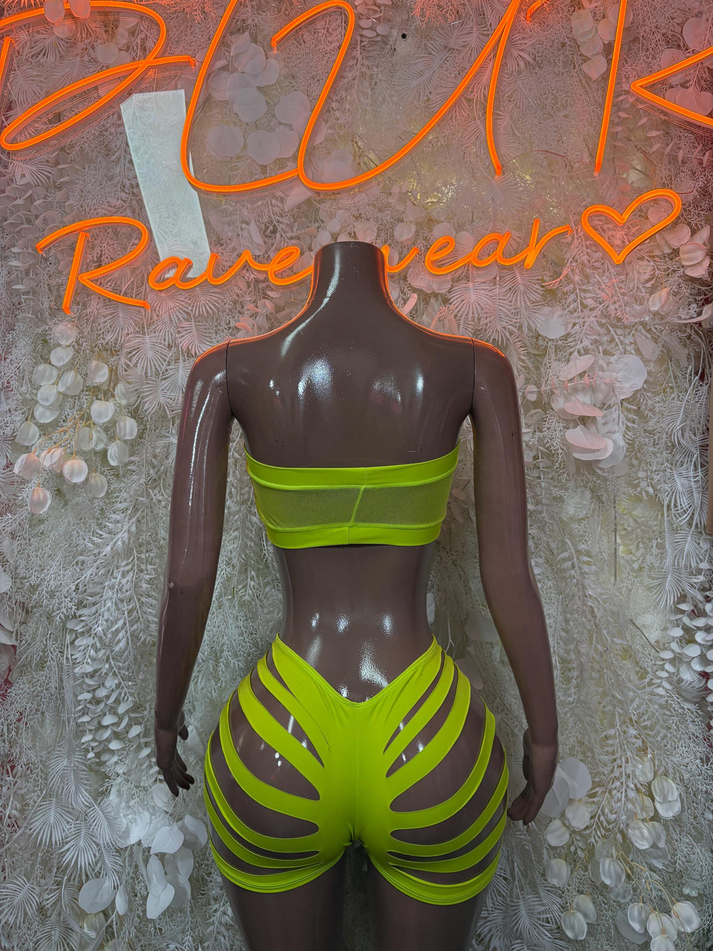 Lime green two-piece rave set with bandeau back top and high-cut shorts with slashed sides