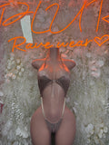 Nude slingshot one-piece bodysuit with front thong straps and center cutout