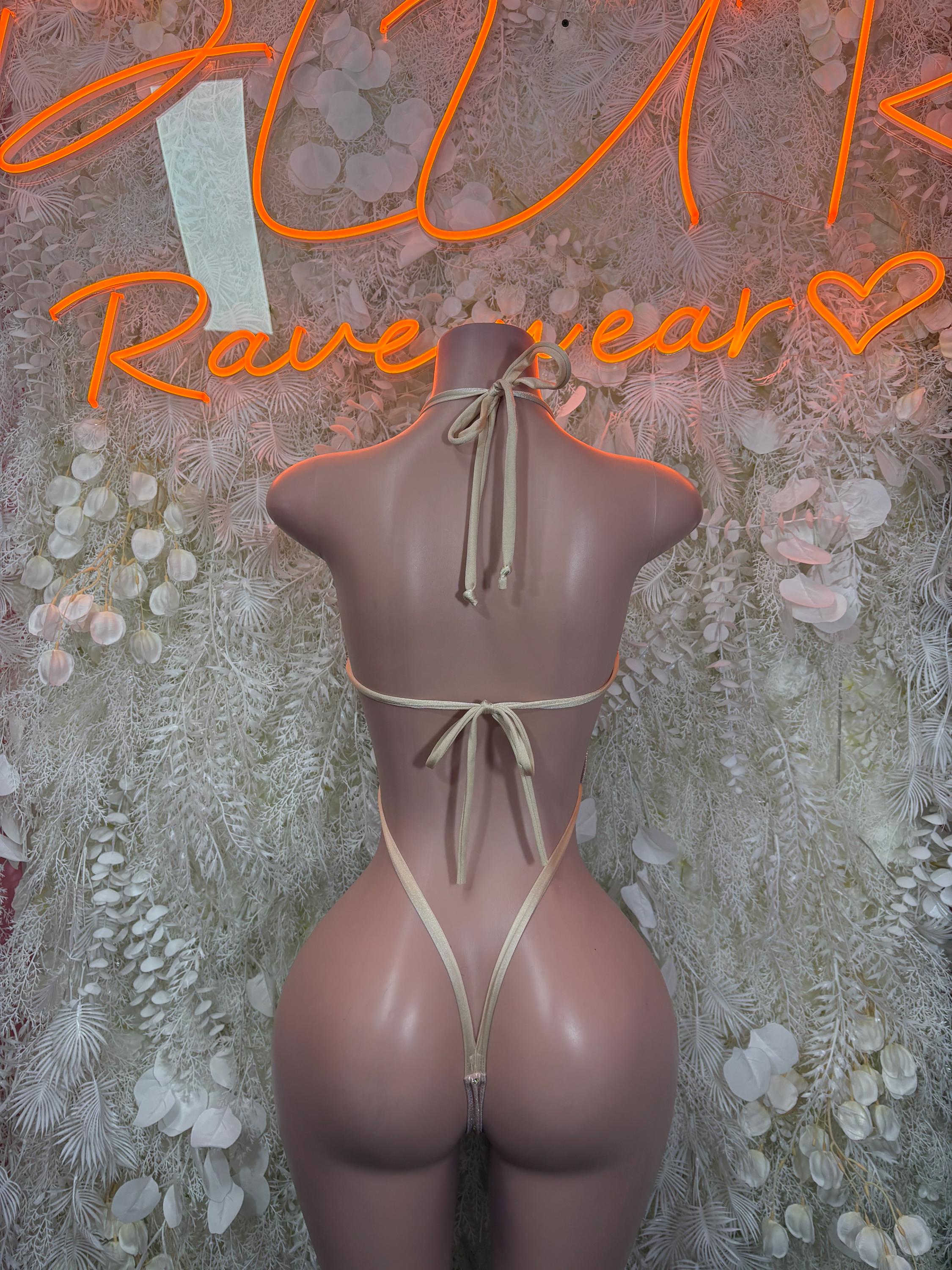 Nude string one-piece bodysuit with back ties and open back cutout