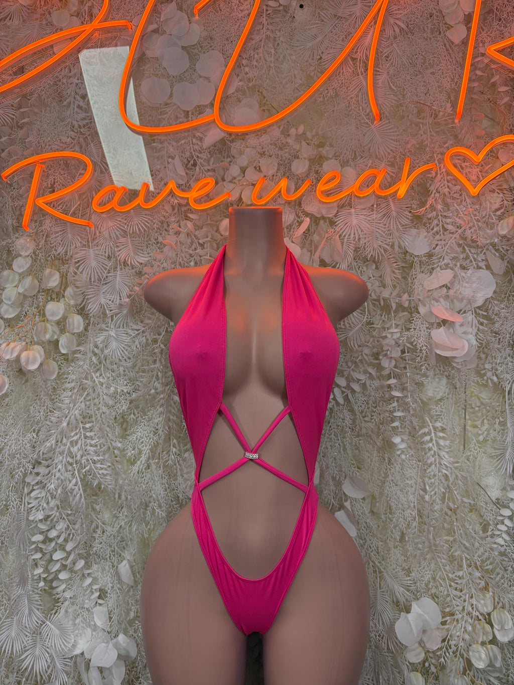 Pink one-piece bodysuit with halter neckline and crisscross back straps