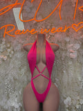 Pink one-piece bodysuit with halter neckline and crisscross back straps