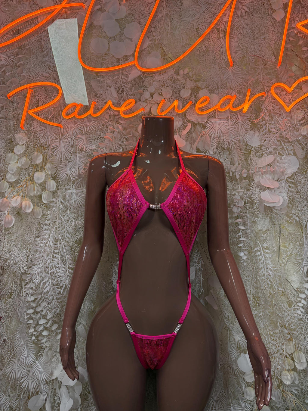 Pink metallic slingshot one-piece bodysuit with cutout bra-style top and thong bottom