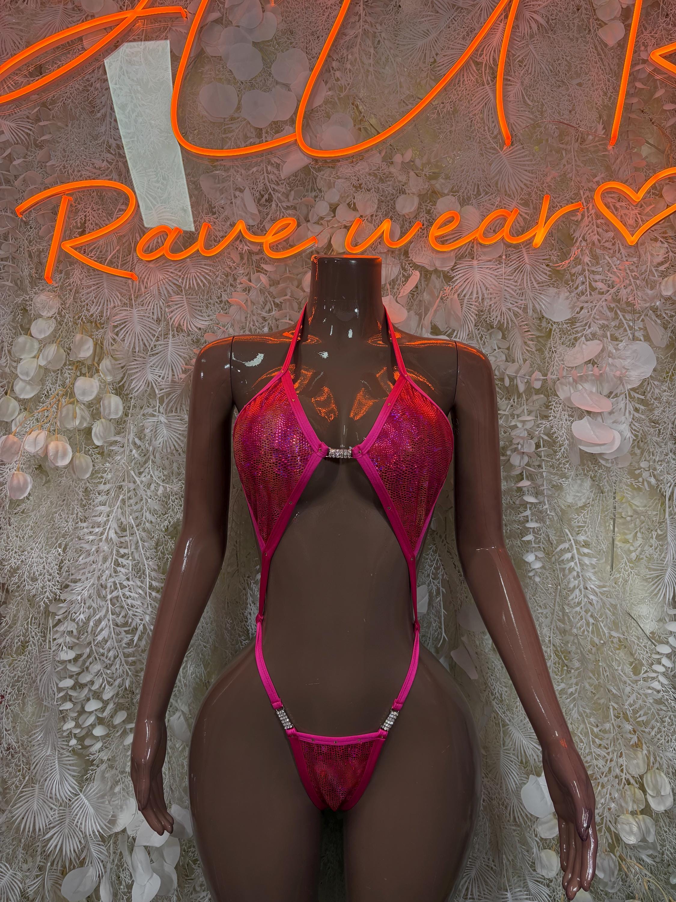 Pink metallic slingshot one-piece bodysuit with cutout bra-style top and thong bottom