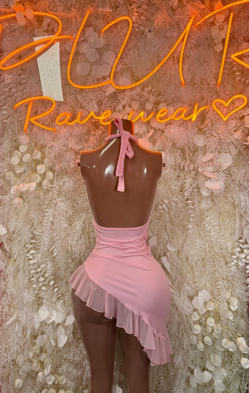 Light pink halter mini dress with neck tie, V-neck cutout and ruffle skirt