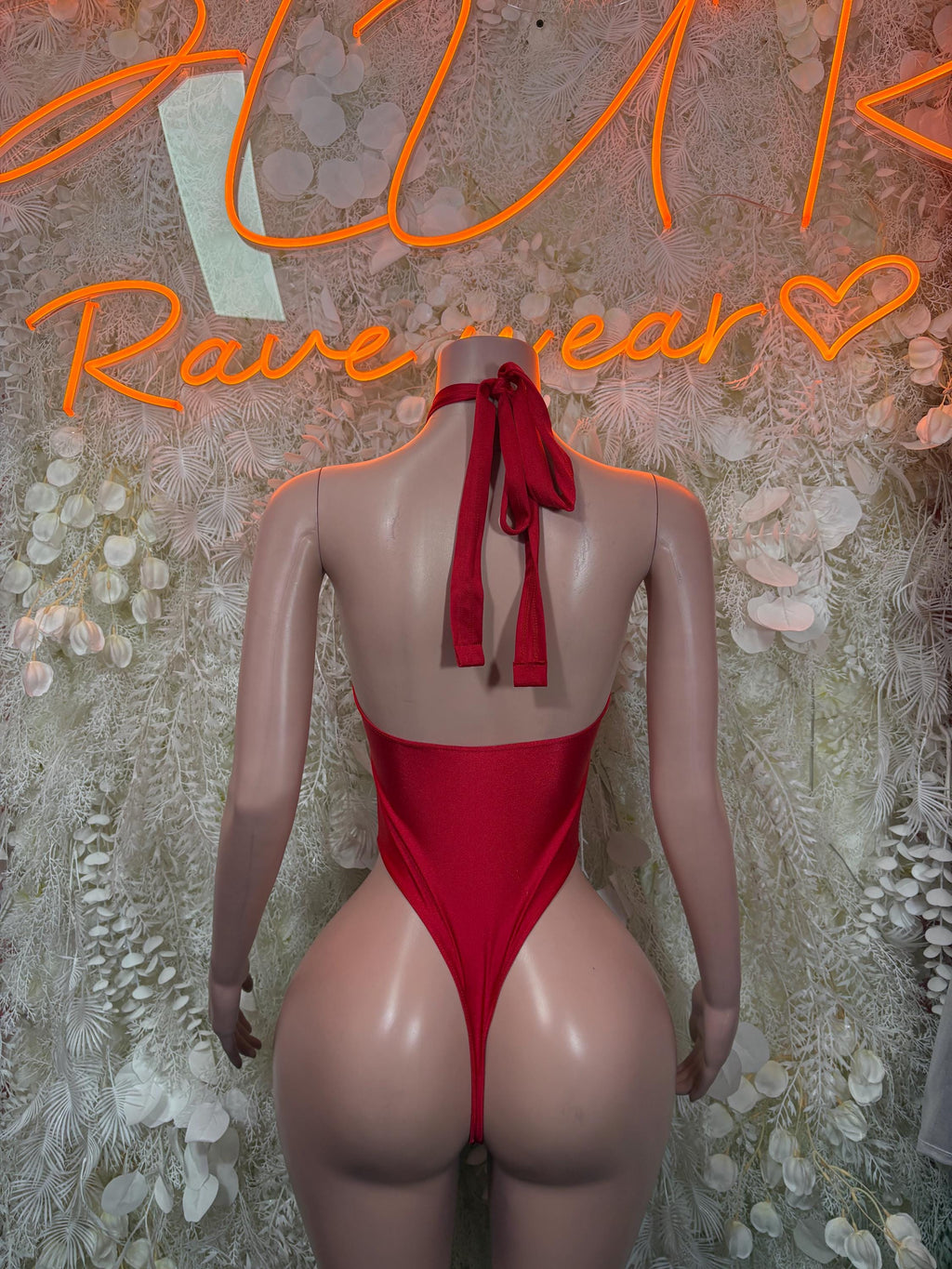 Red backless bodysuit with neck halter and tie bow at center back