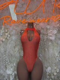 Orange one-piece bodysuit with halter neck and oval chest cutout