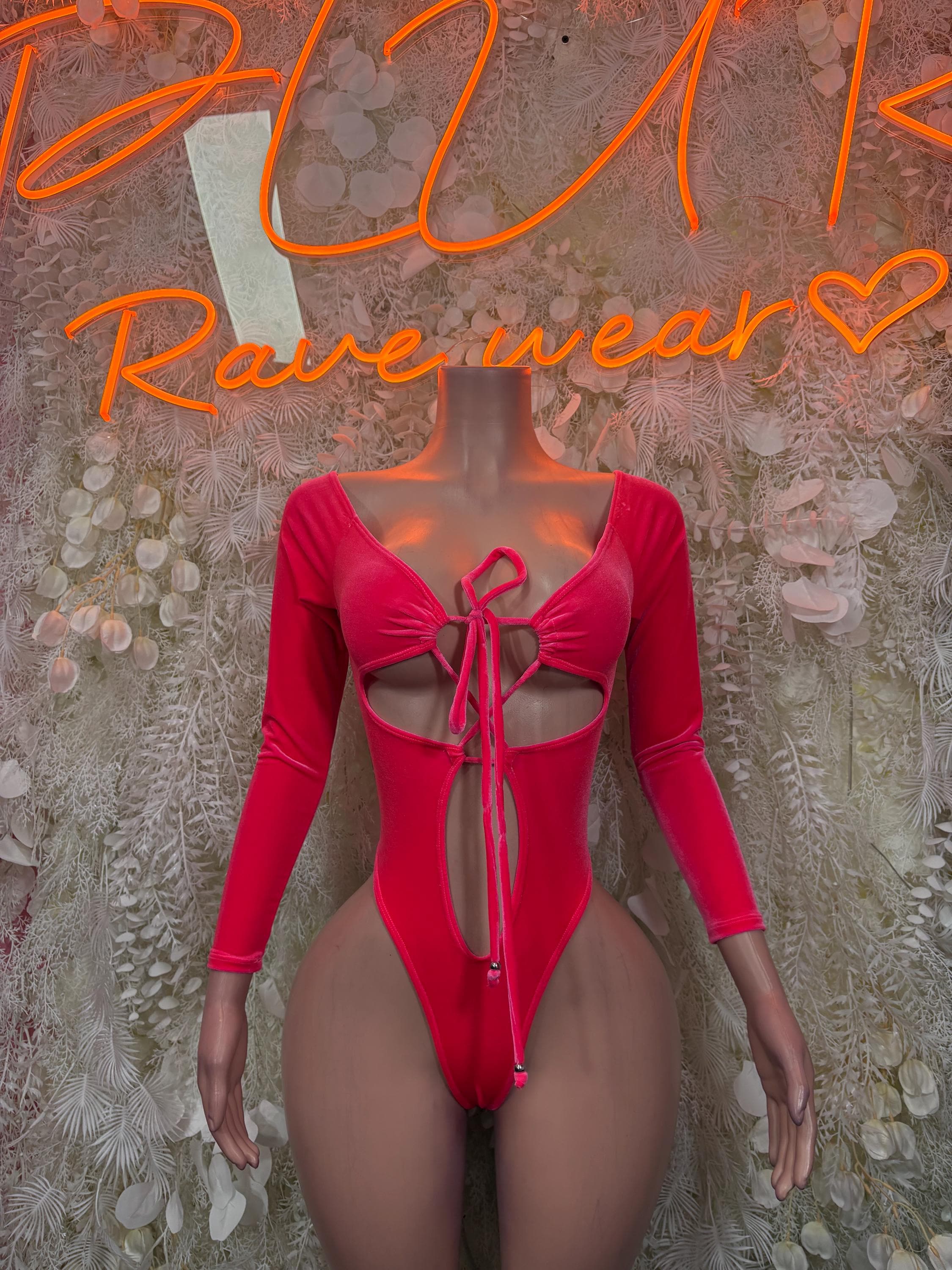 Pink velvet one-piece bodysuit with long sleeves and lace-up front
