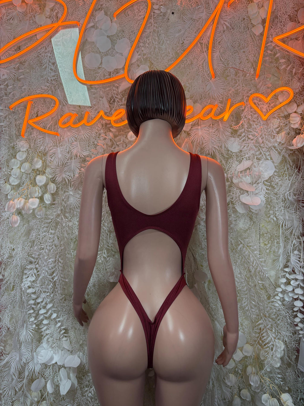Burgundy strappy bodysuit with open back and high-cut bottom