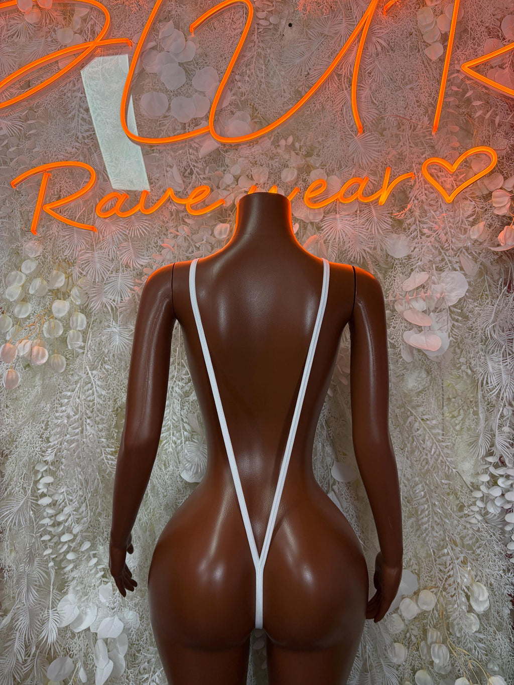 White fishnet one-piece with crisscross back straps and open-back V silhouette