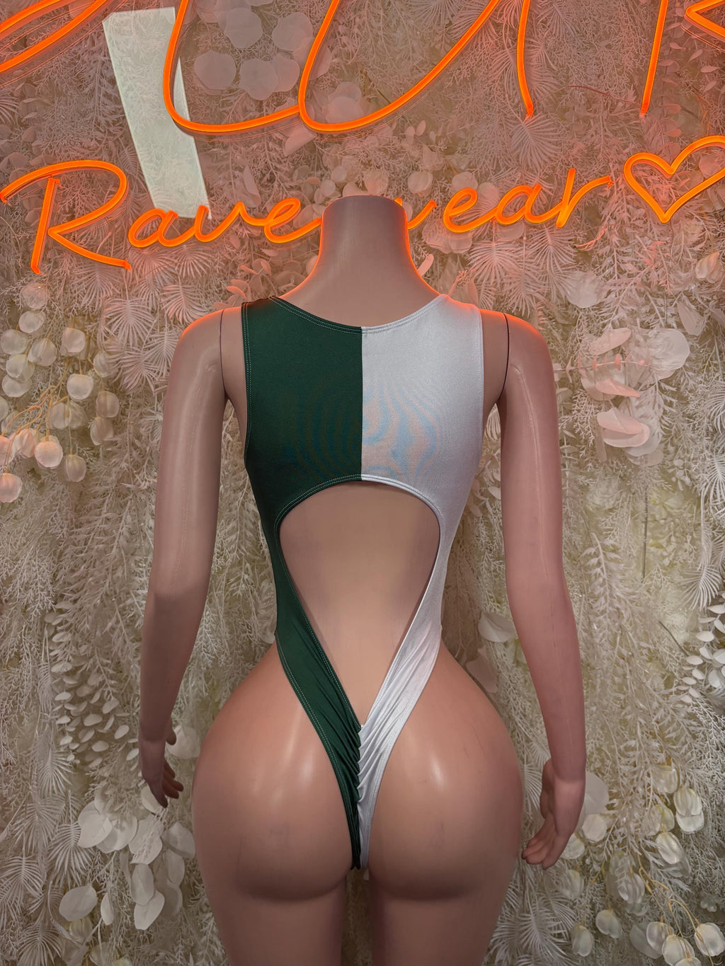 Green and white one-piece bodysuit with open back and contrasting center panel