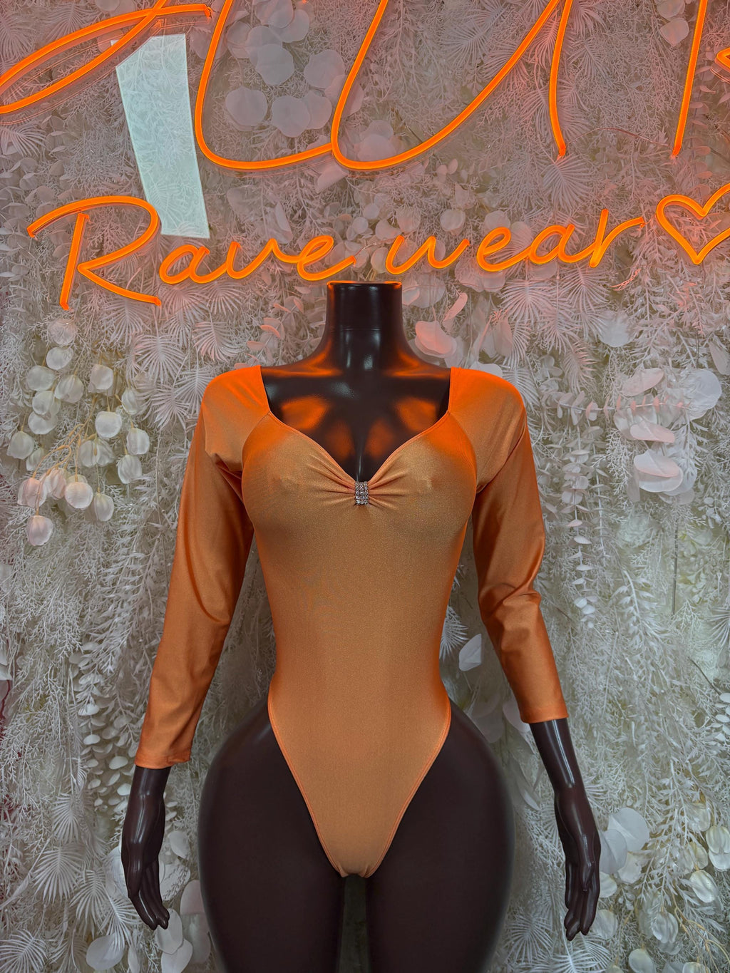Orange one-piece bodysuit with long sleeves and deep V-neck front