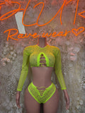 Neon lime green two-piece rave outfit: cropped long-sleeve top and high-cut bottoms.