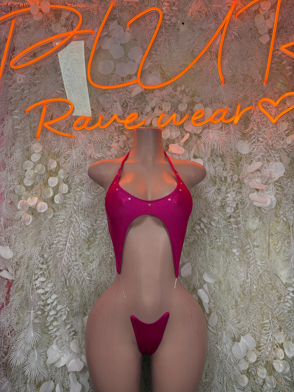 Pink one-piece slingshot swimsuit with heart-shaped cutout and underwire cups