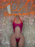 Pink one-piece slingshot swimsuit with heart-shaped cutout and underwire cups