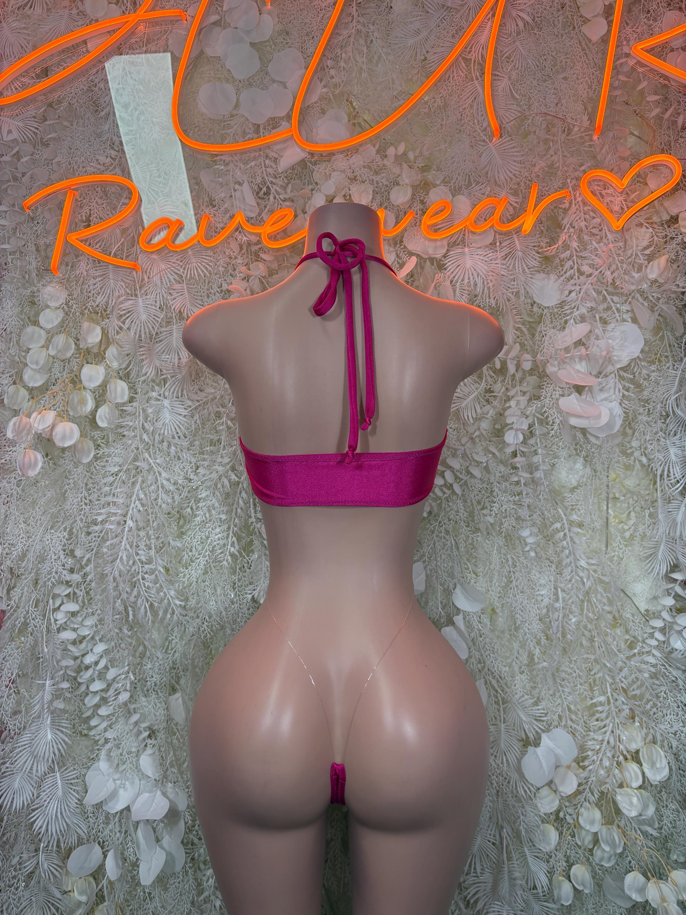 Pink one-piece slingshot swimsuit with open back and vertical tie strap