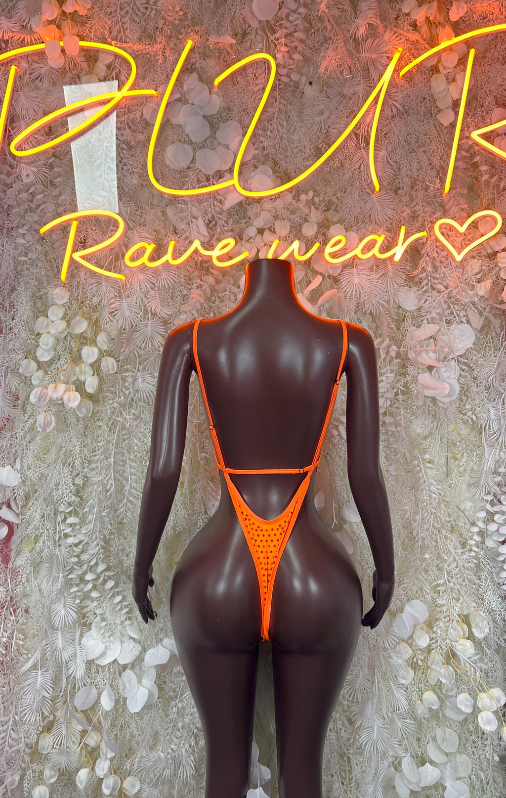 Back view of orange rhinestone bodysuit with thin straps