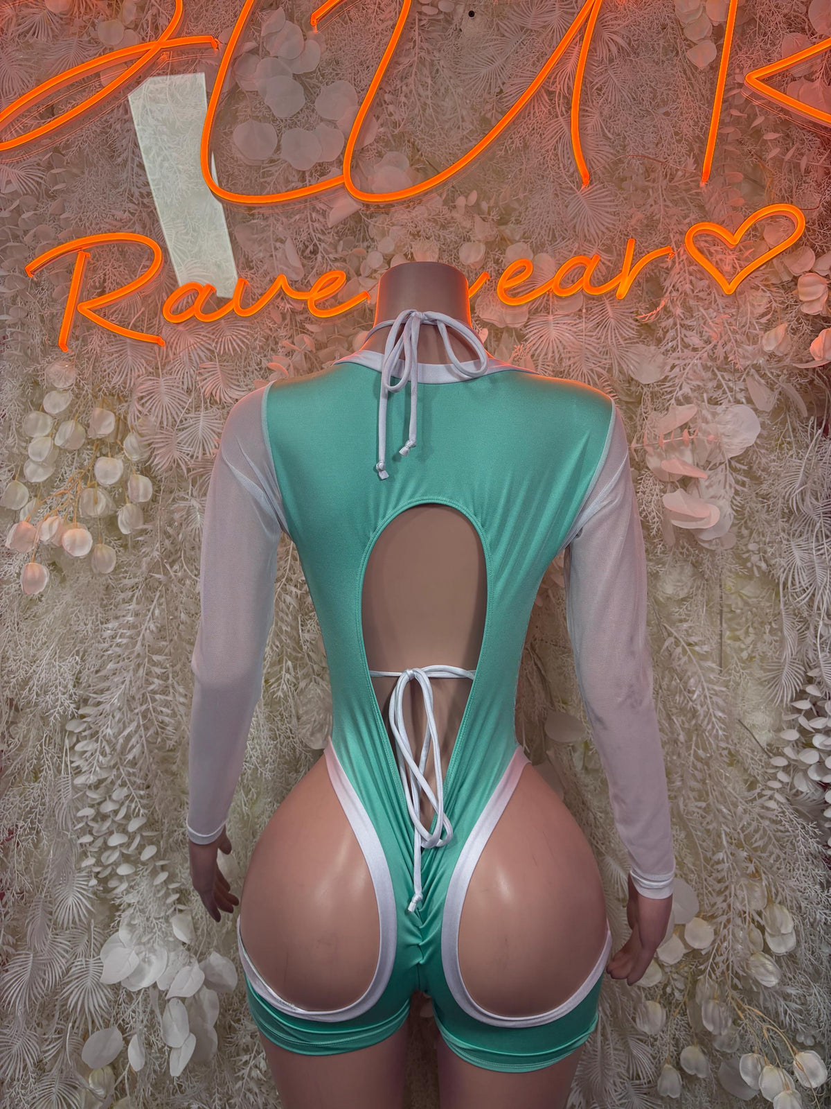 Backless teal cheetah-print bodysuit with crisscross lace back and long sheer sleeves