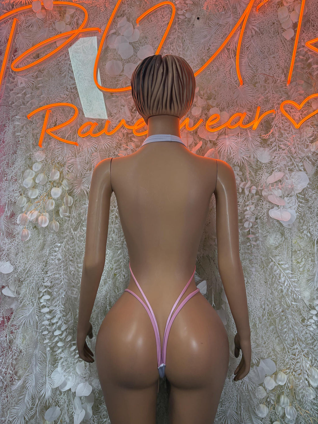 White and pink slingshot bodysuit, back view with thin strap and tie accents