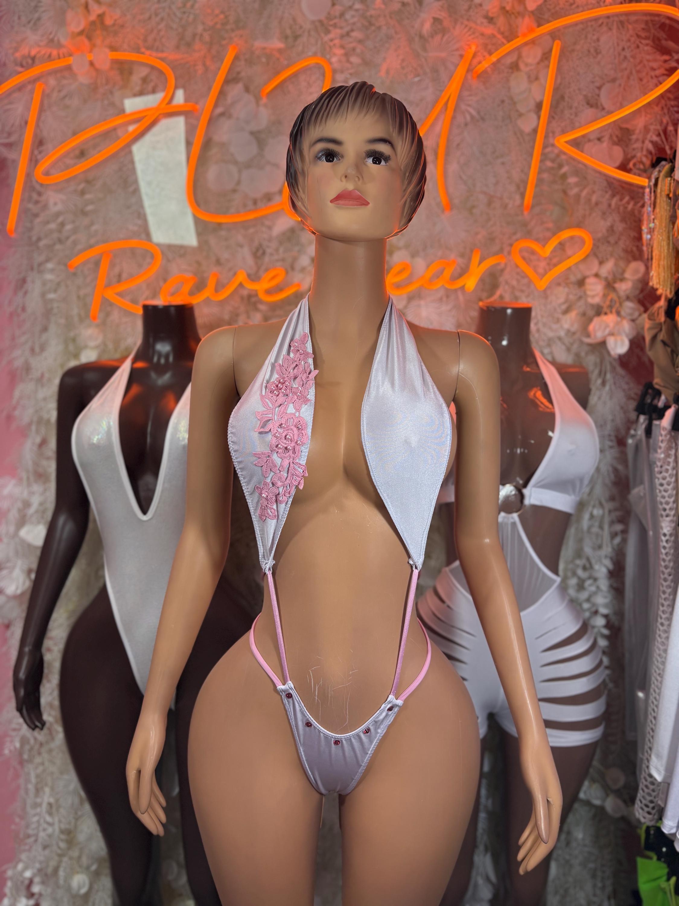 White one-piece rave bodysuit with V neckline and pink lace trim, thin straps