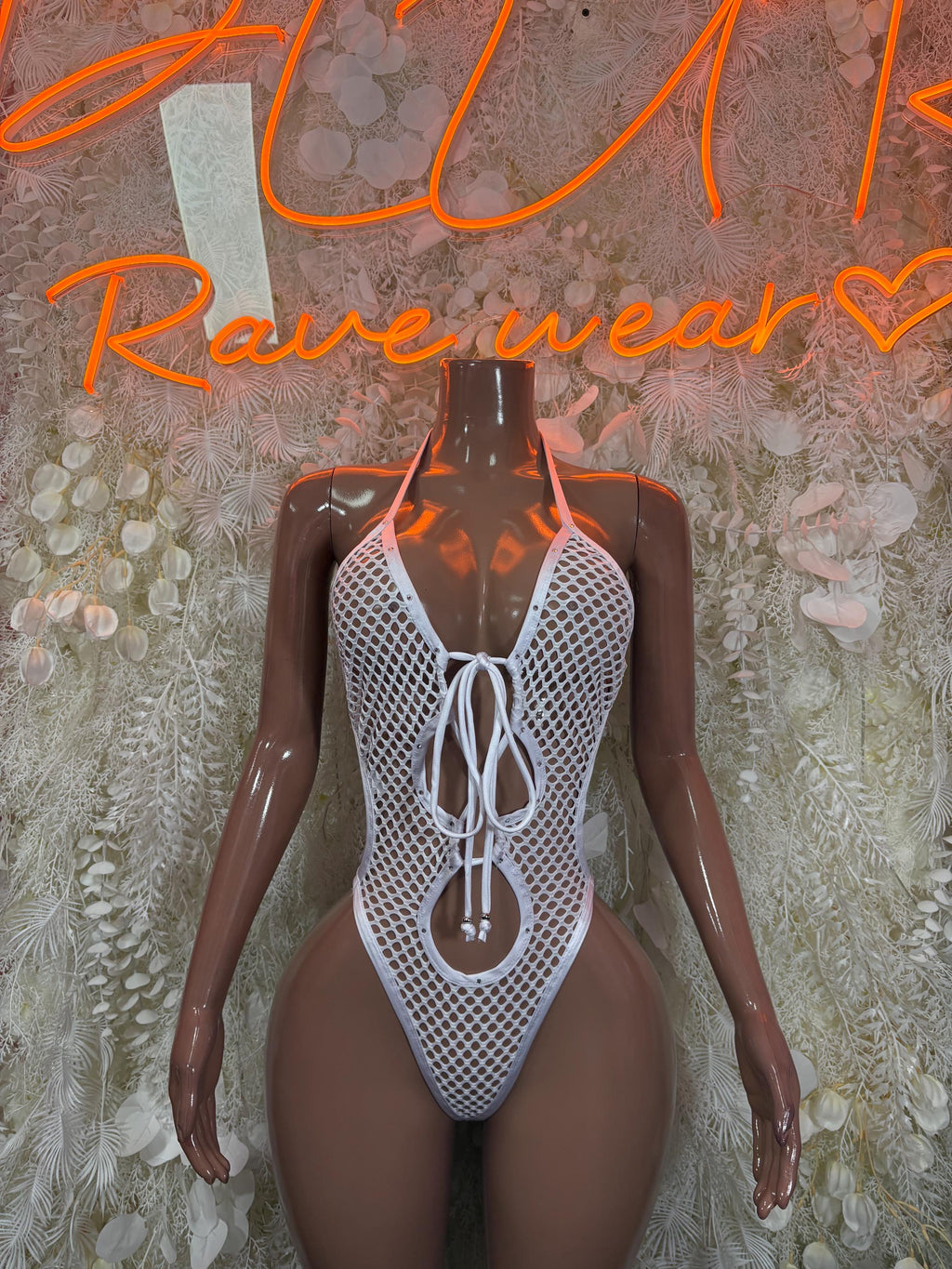 White fishnet bodysuit with lace-up front and thong back
