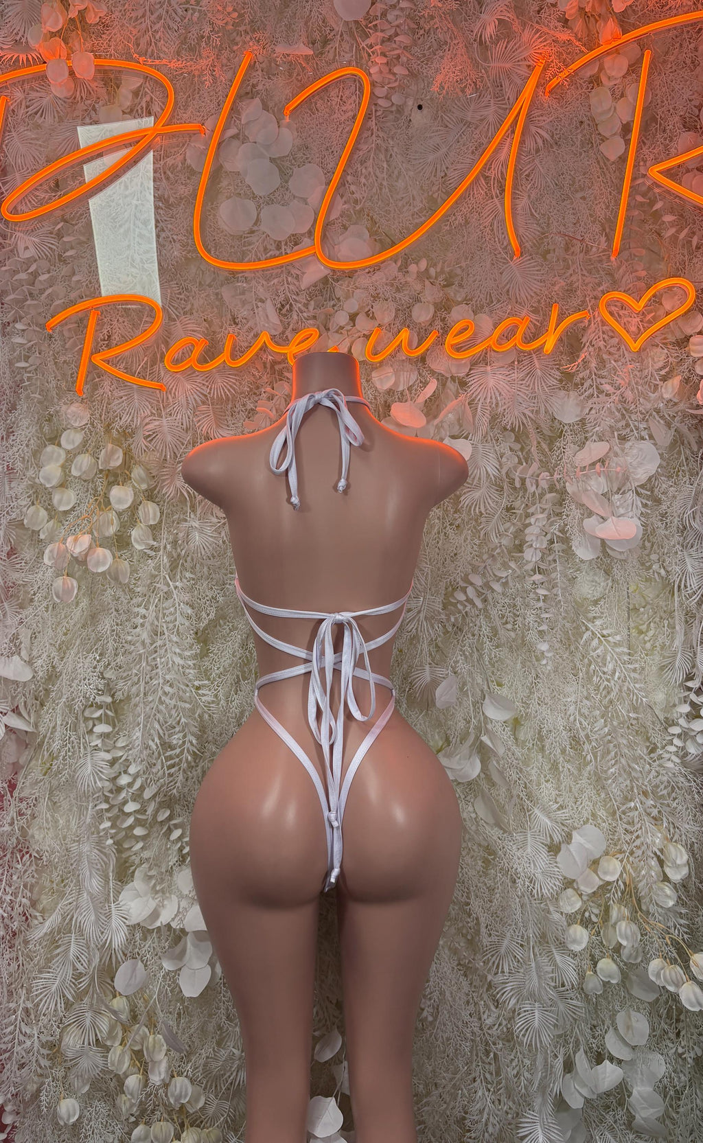 White backless string one-piece bodysuit with lace-up tie and cheeky coverage