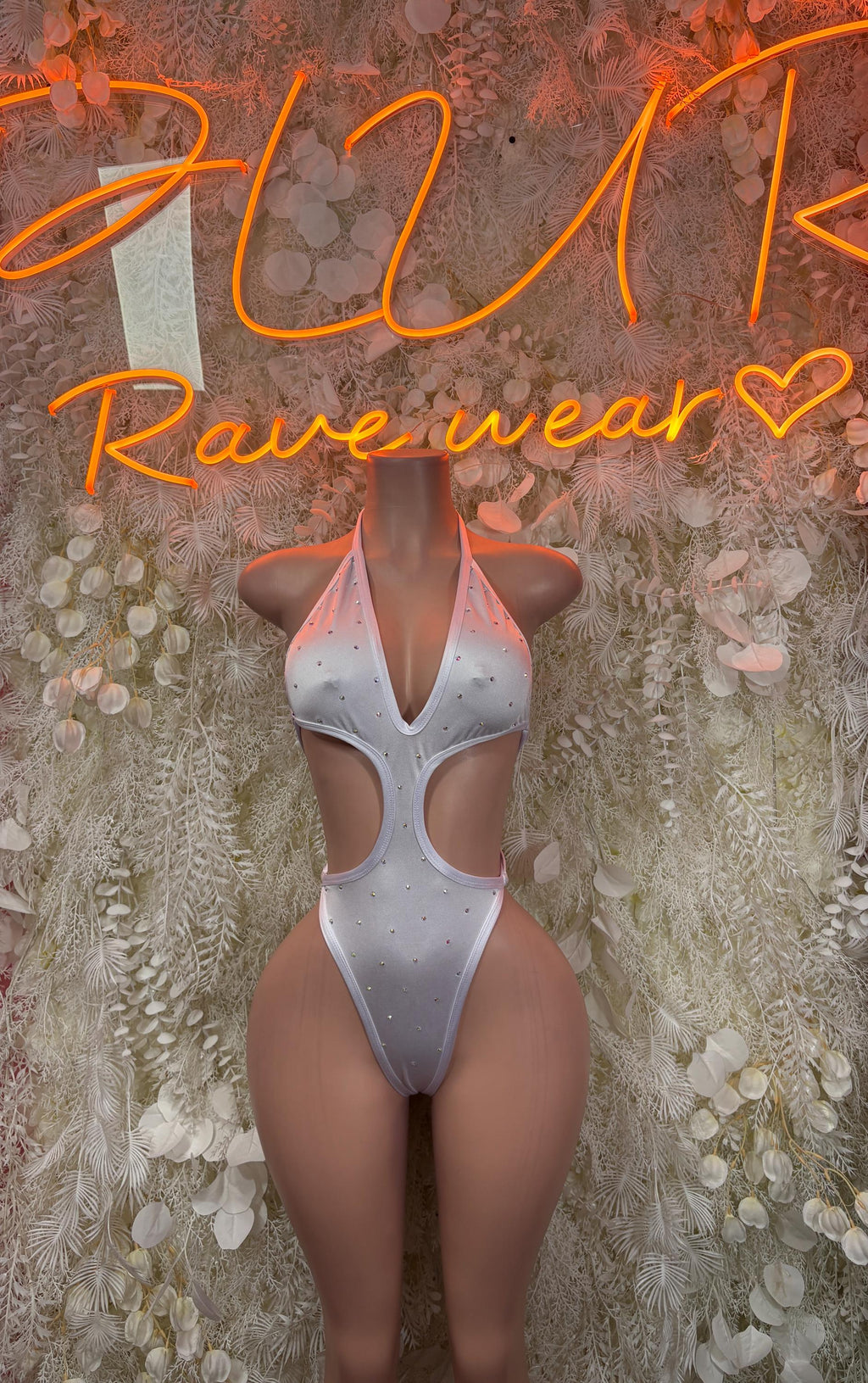 White cutout one-piece bodysuit with deep V neckline and sparkly speckled fabric