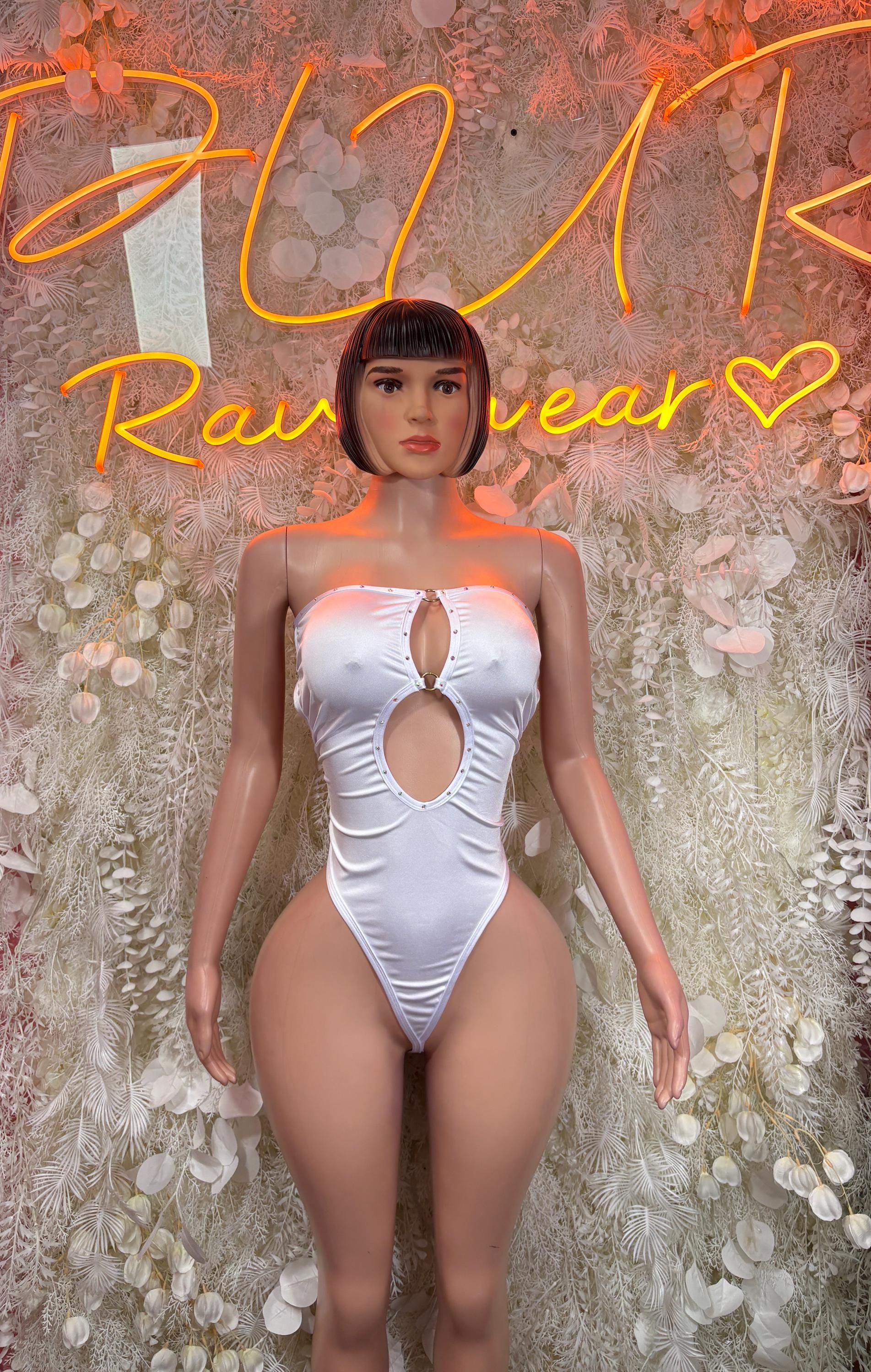 White festival bodysuit with oval front cutout and high-leg one-piece fit