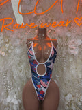 One-piece swimsuit with patriotic flag print, halter neckline, high-cut legs