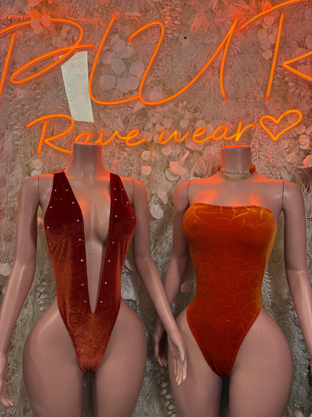 Velvet one-piece bodysuit in deep red and orange, with V-neck front and high-cut legs.