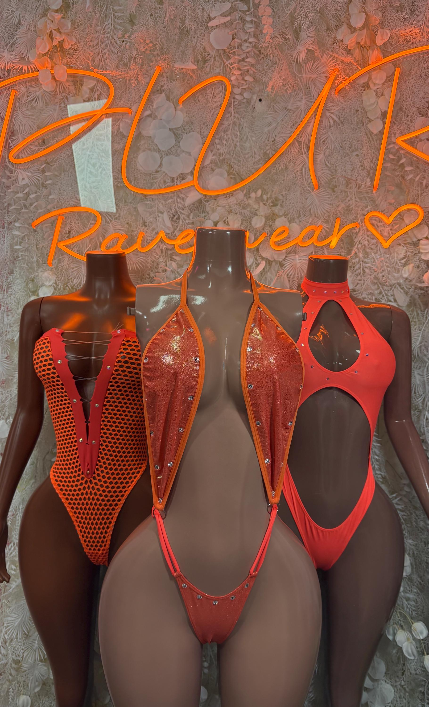 Orange cutout bodysuit displayed on mannequins, high-cut mesh straps