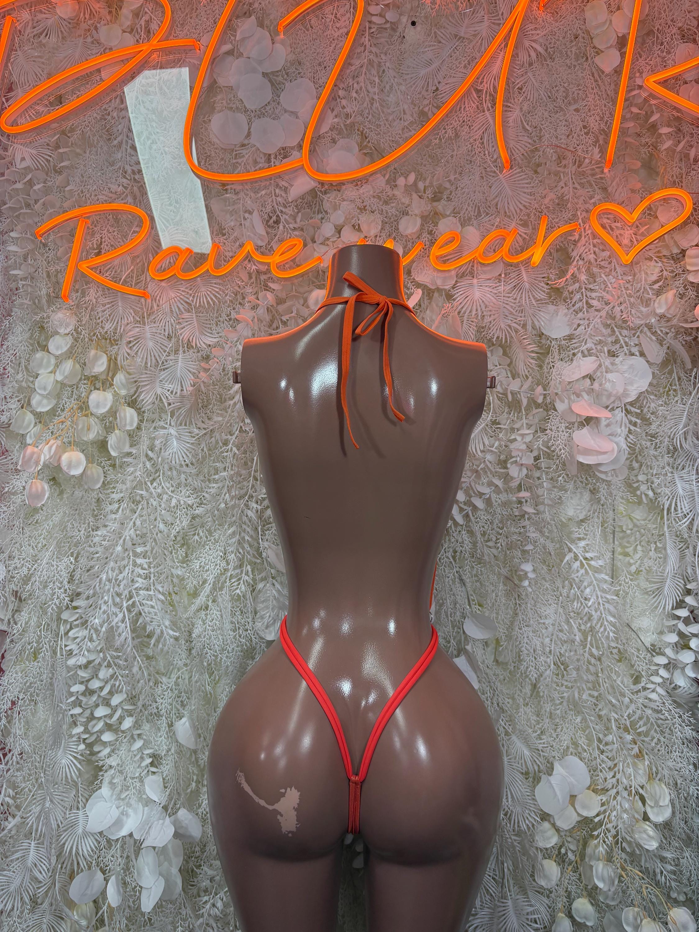 Orange high-cut bodysuit with back ties and minimal front coverage