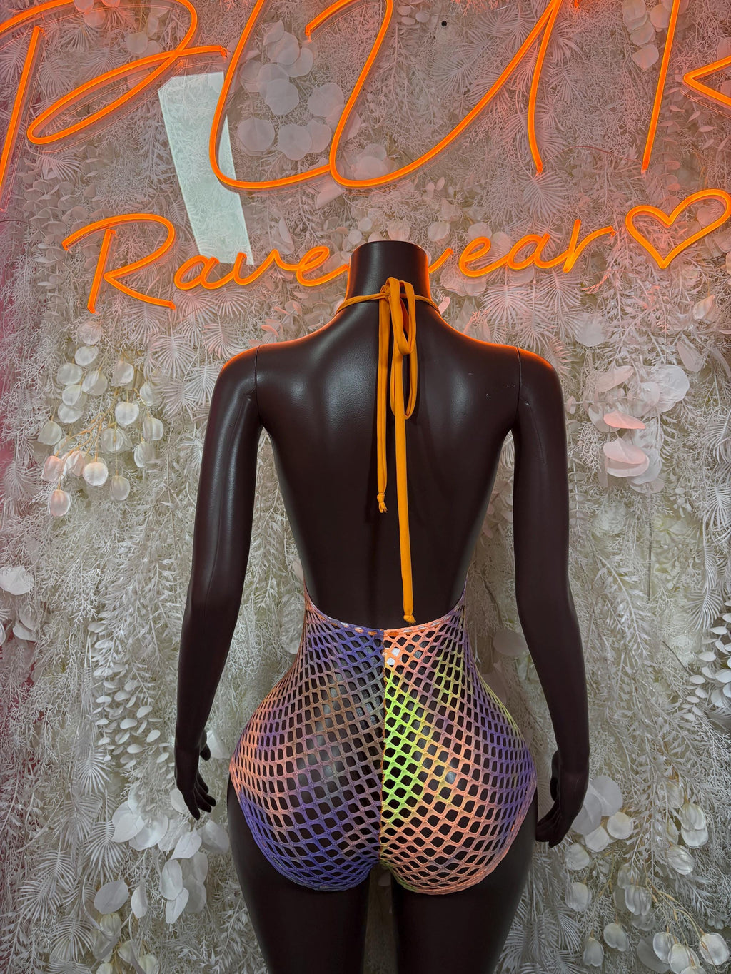 Multicolor rave bodysuit back view with tie strings and purple mesh lower panel