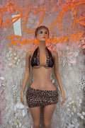 Leopard print dance skirt set with halter bra and matching mini skirt, front view.