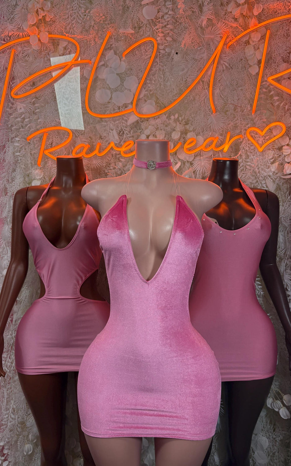 Pink sleeveless mini dress with deep V neckline and fitted ruched texture