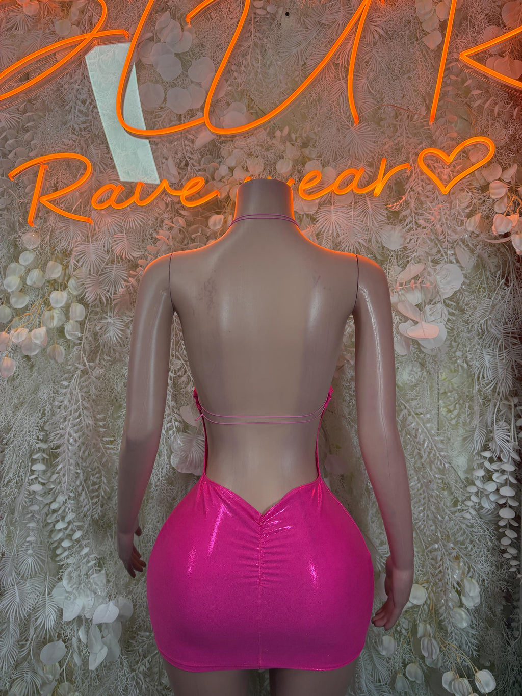 Neon pink V-back mini rave dress with thin straps and ruched bodycon fit