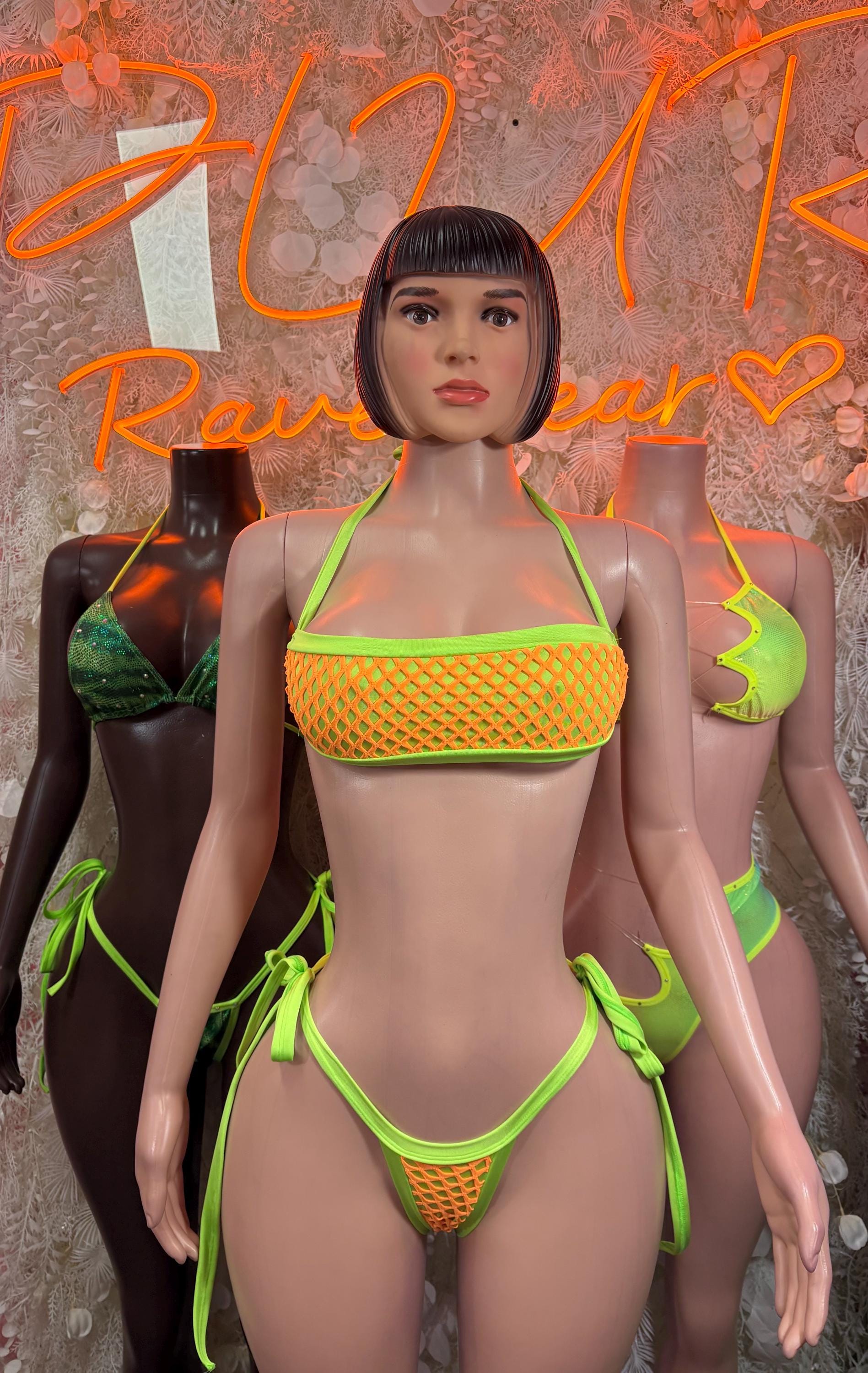 Green metallic two-piece bikini with neon trim, triangle top and tie-side bottoms on model