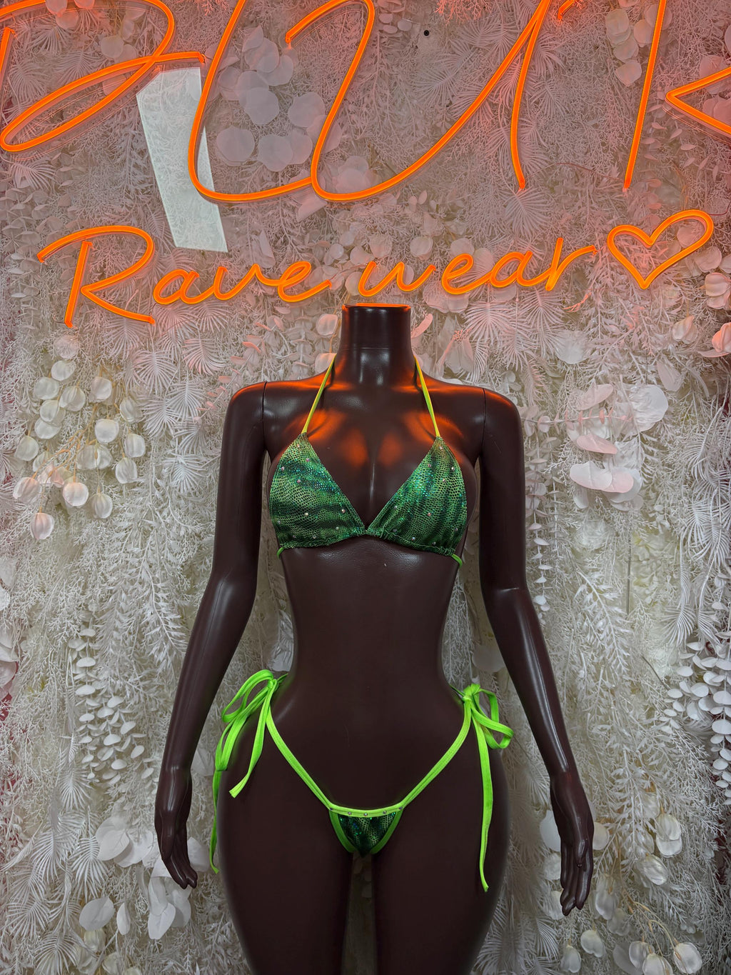 Green metallic bikini set with neon straps, triangle top and tie-side bottom on mannequin