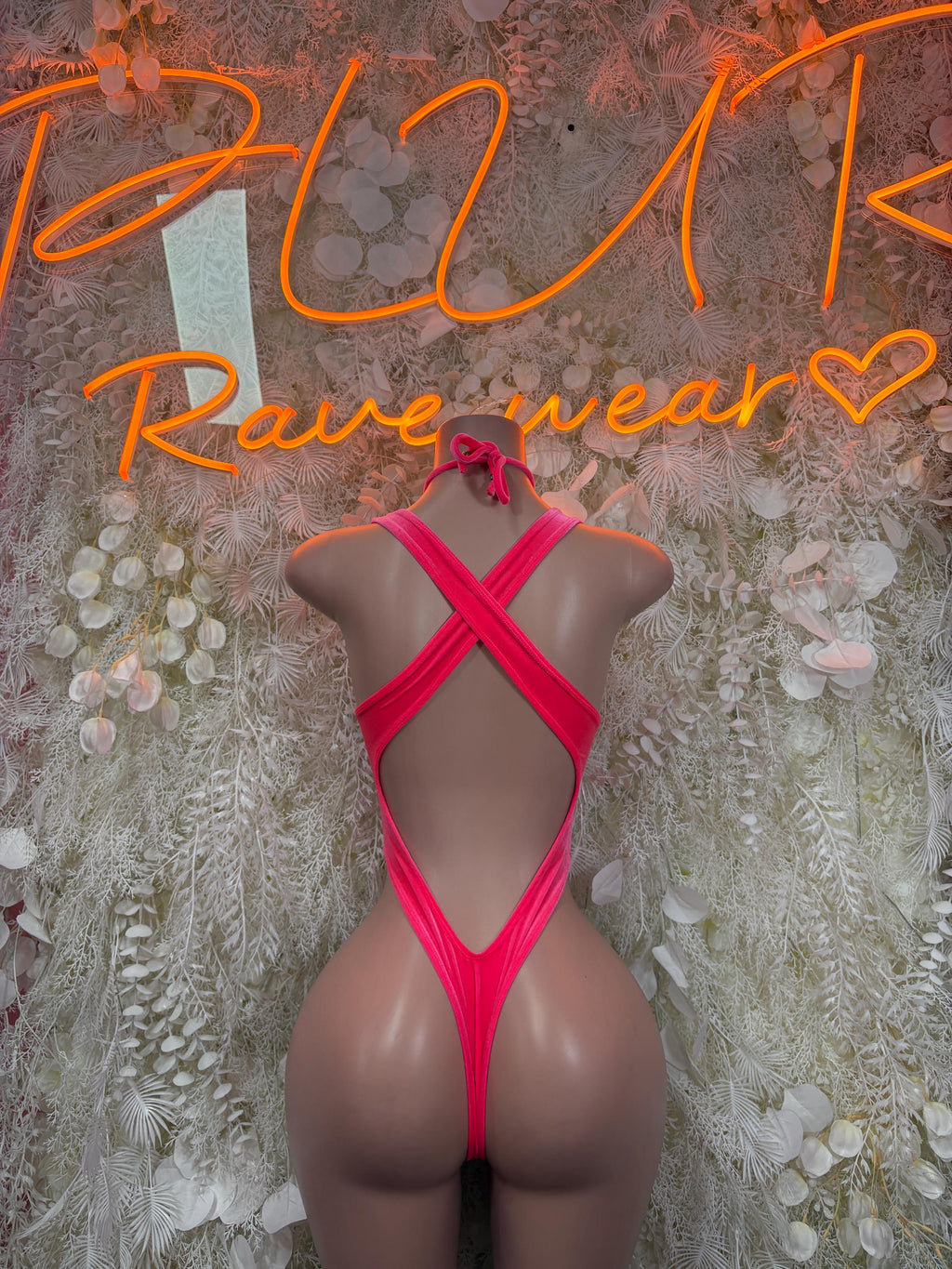 Pink velvet bodysuit with crisscross back straps and high-cut legs