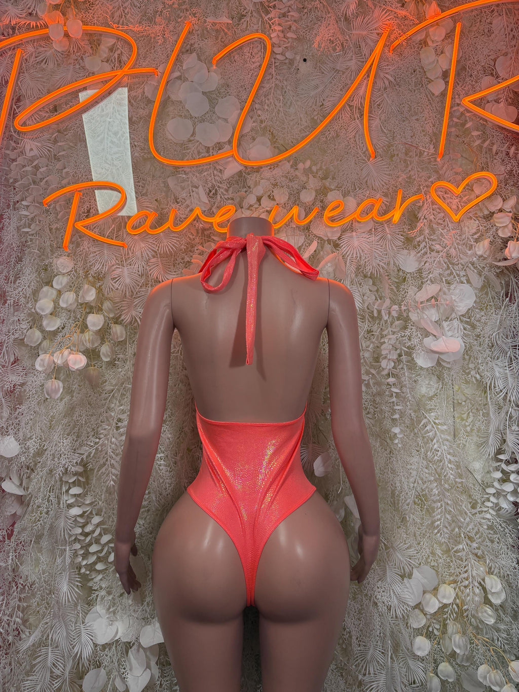 Coral backless bodysuit with bow tie at center back and thong-style bottom