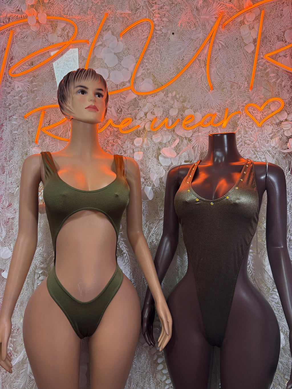 Metallic green sleeveless bodysuit worn by model, low-cut front