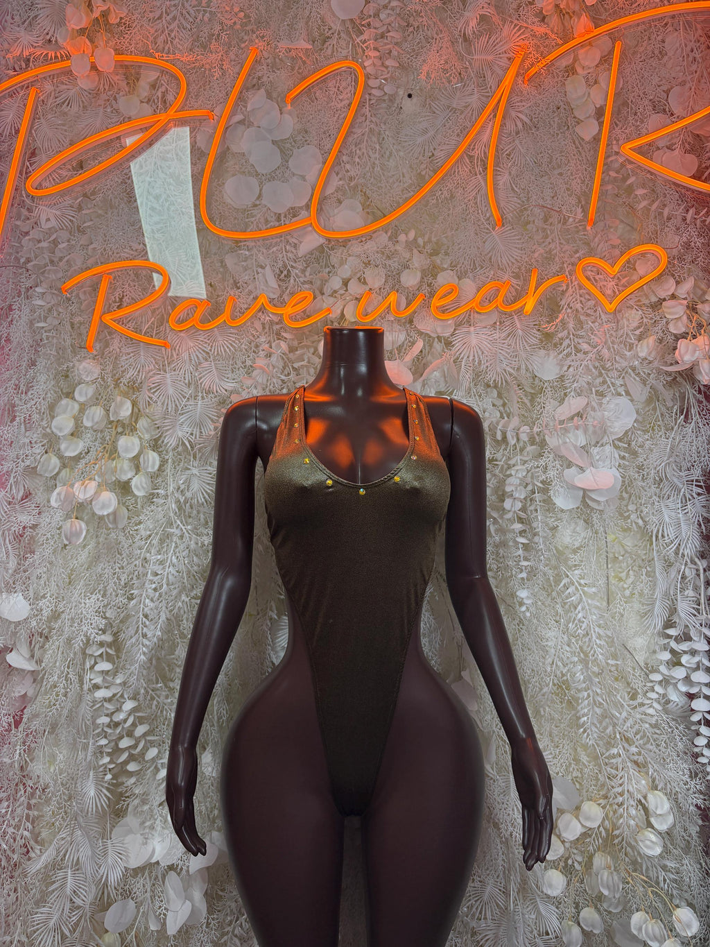 Metallic green bodysuit on mannequin, deep V neckline and sleeveless cut