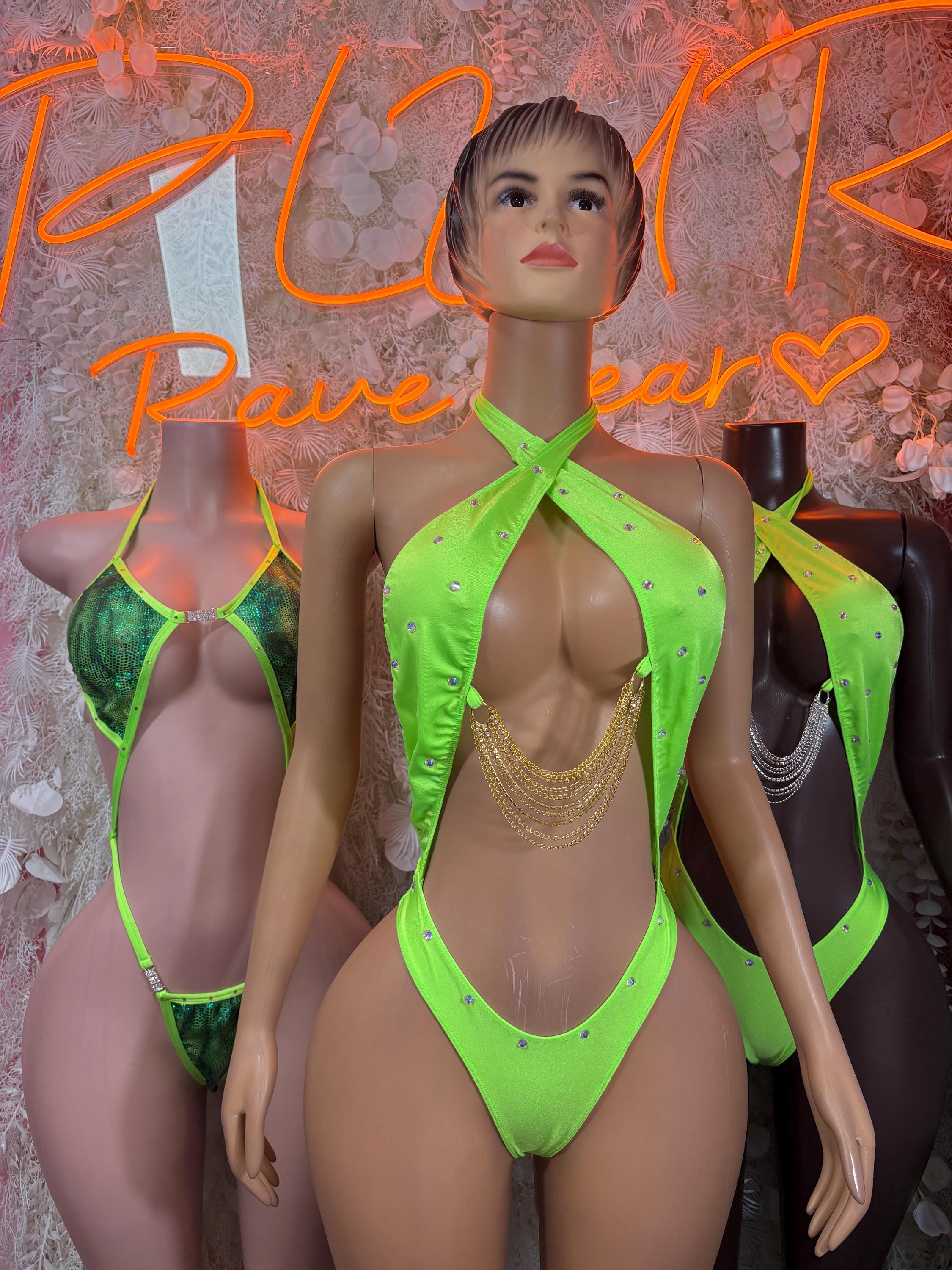 Neon green halter bodysuit with rhinestone accents and gold chain drape