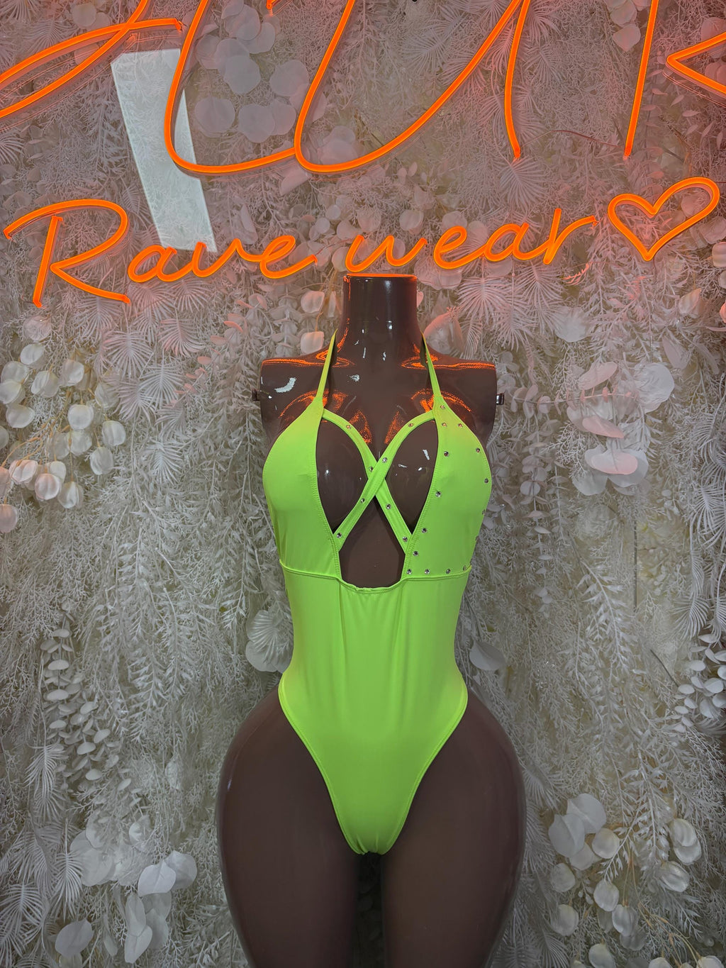 Neon green cutout bodysuit with strappy neckline and high-cut legs.