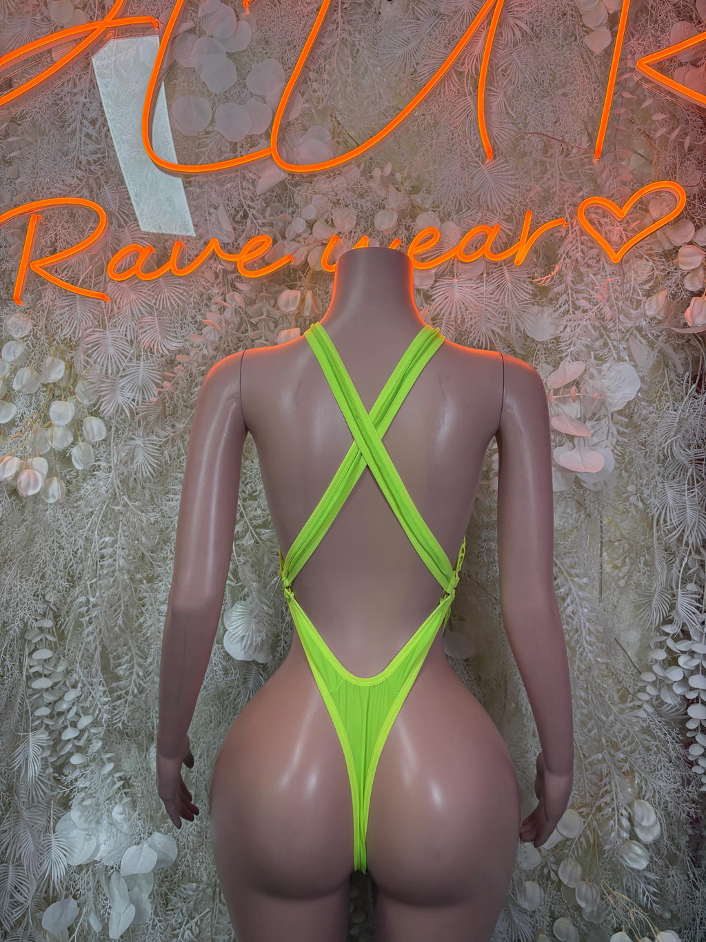 Neon green fishnet bodysuit, X-back straps and high-cut brief leg openings