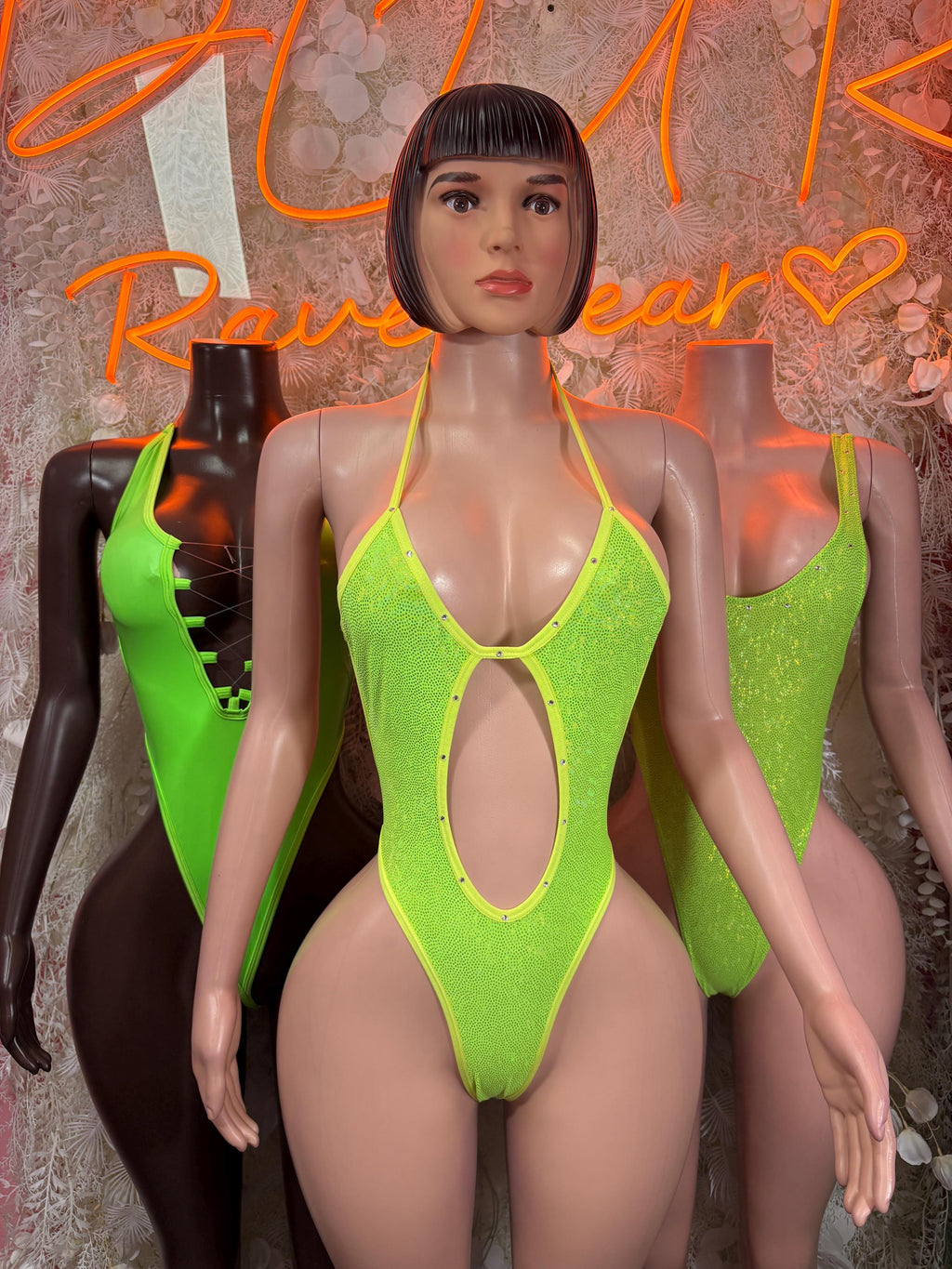 Neon green metallic halter bodysuit with oval cutout and strappy backless design