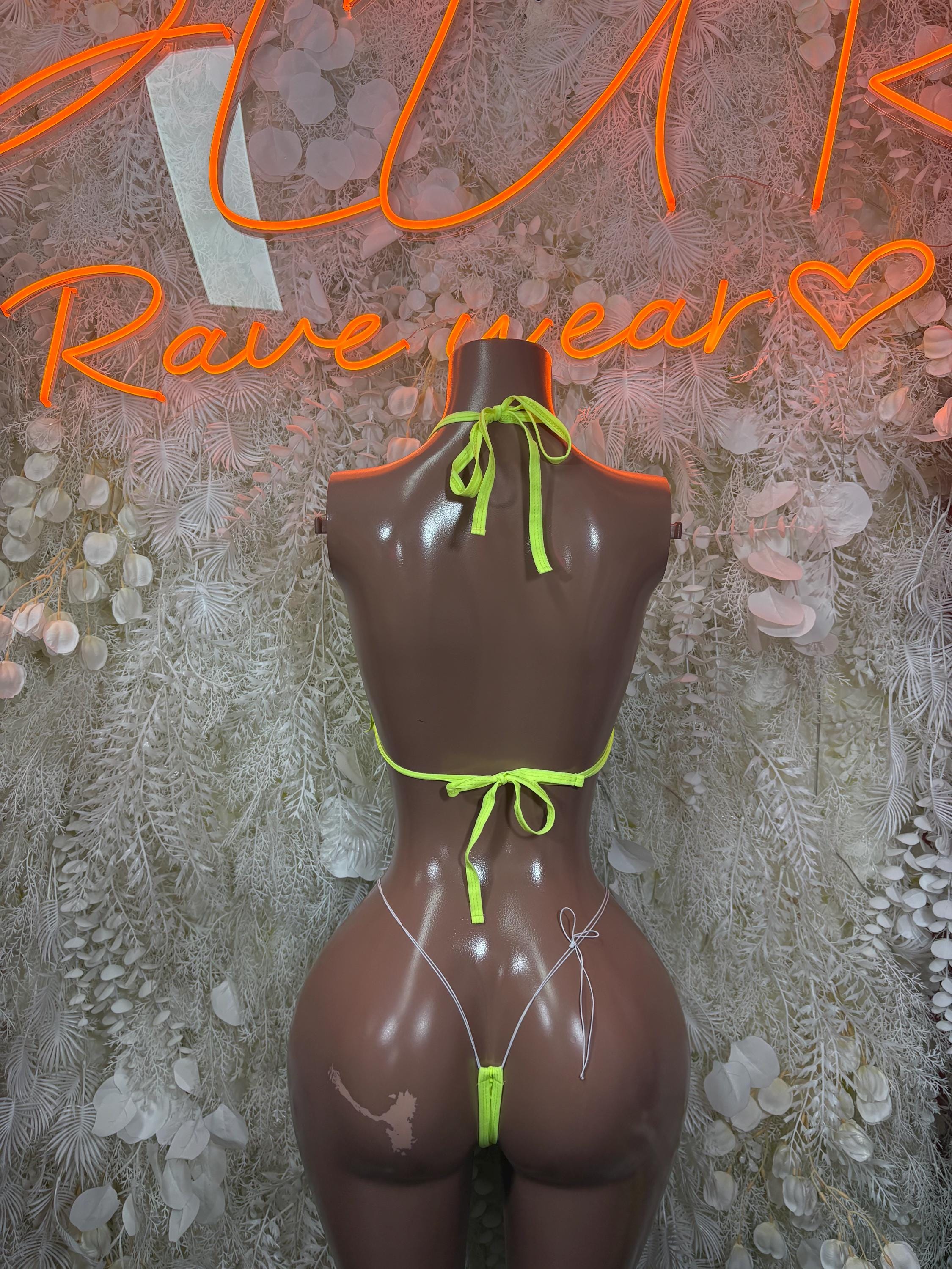 Neon green fringe two-piece set on mannequin, strappy thong bikini and tie-back top