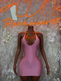 Pink mini dress with halter neckline and racerback straps