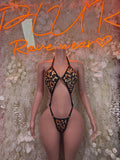 Leopard print one-piece with black V-neck and strappy harness